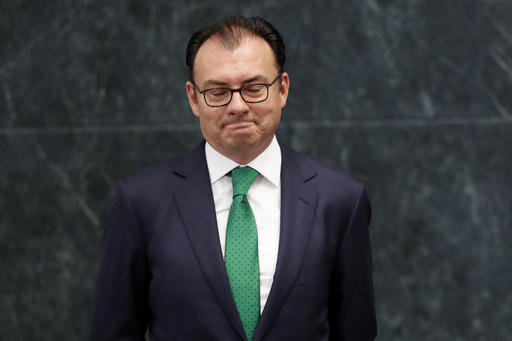 Mexico's Finance Secretary Luis Videgaray looks down as President Enrique Pena Nieto announces Videgaray's resignation at Los Pinos presidential residence in Mexico City
