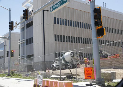 Workers toil on one of the buildings on the campus of the Veterans Administration hospital under construction Thursday