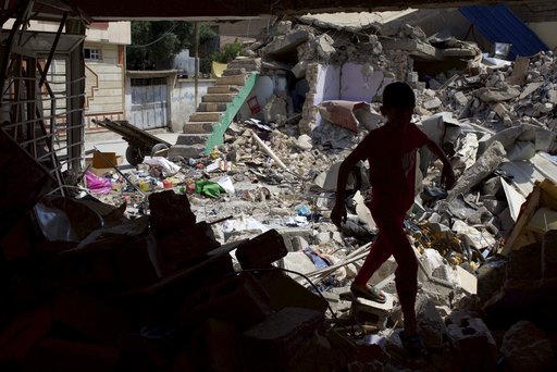 A child plays among the ruins of a house in western Mosul on Friday