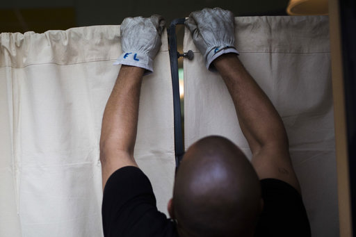 A worker prepares the booths at a polling station in Saint Cloud