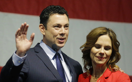 U.S. Rep. Jason Chaffetz waves to the Utah GOP Convention while his wife Julie looks on Saturday