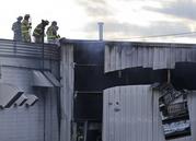 Firefighters work at the scene of a factory fire in New Windsor