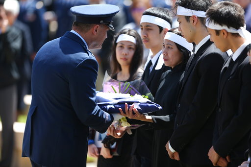 Maj. Gen. Michael E. Stencel presents a United States flag to the family of Ricky Best at Best's his burial service with military honors at Willamette National Cemetery in Portland