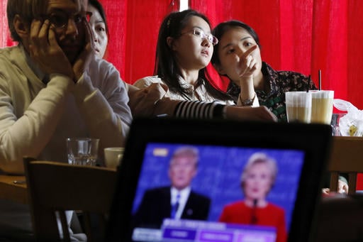 Chinese students chat as they watch a live broadcasting of the presidential debate between Democratic presidential nominee Hillary Clinton and Republican presidential nominee Donald Trump