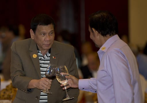 Philippine's President Rodrigo Duterte toasts a drink with Brunei Foreign Minister and Prime Minister Sultan Hassanal Bolkiah during Association of Southeast Asian Nations (ASEAN) summit welcome dinner in Vientiane