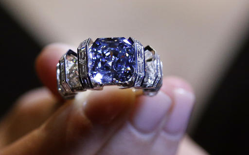 A model shows 'The Sky Blue Diamond' ring at the auction house Sotheby's in London