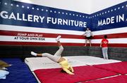 Displaced kids play while sheltering at Gallery Furniture