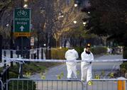 Emergency officials walk near evidence markers on the west side bike path in lower Manhattan