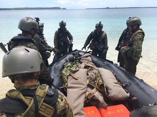 Japanese soldiers practice rubber craft raids during multinational exercises between the U.S.