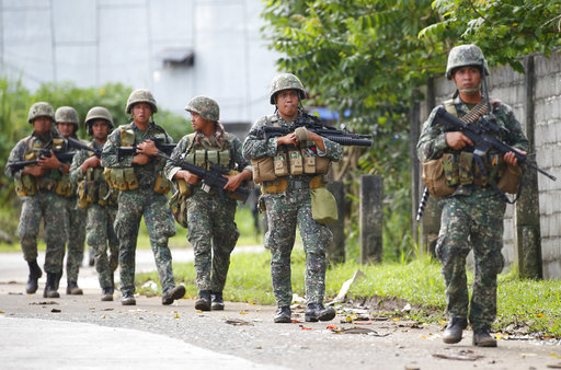 Philippine marines walk to the frontline in the continuing assaults to retake control of some areas of Marawi city Sunday