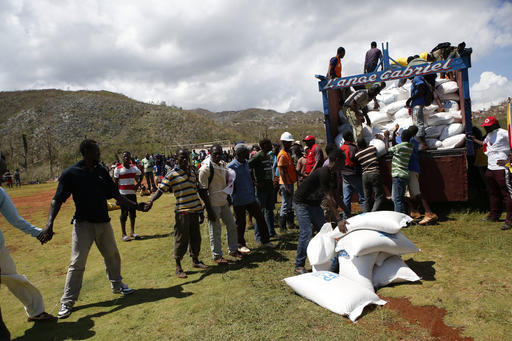 Sacks of donated rice are loaded onto a truck for local distribution after being delivered by a U.S. military helicopter
