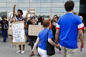 Protesters chant as spectators arrive outside Nippert Stadium before a soccer game during a demonstration on the University of Cincinnati campus demanding that a white former police officer be tried a third time in the fatal shooting of an unarmed black motorist