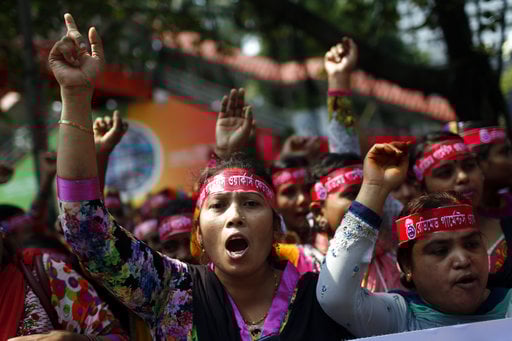 Bangladeshi garment workers shout slogans as they participate in a May Day rally in Dhaka