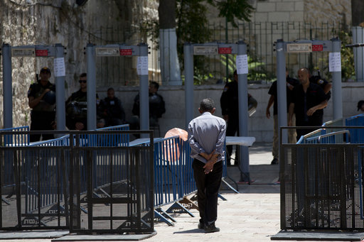 A Palestinian man walks towards a metal detector at the Al Aqsa Mosque compound in Jerusalem's Old City