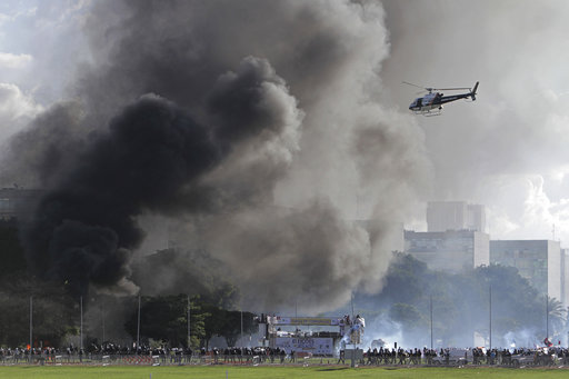 Demonstrators clash with police during an anti-government protest in Brasilia