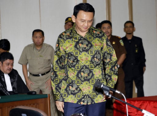Jakarta Governor Basuki "Ahok" Tjahaja Purnama takes his seat for his court hearing in Jakarta