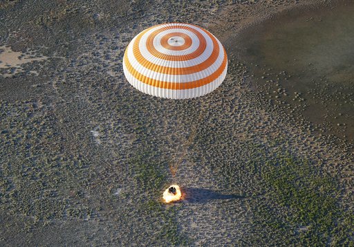 A Russian Soyuz capsule carrying two astronauts after a half-year aboard the International Space Station lands in a remote area outside the town of Dzhezkazgan