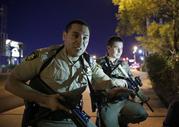 Police officers advise people to take cover near the scene of a shooting near the Mandalay Bay resort and casino on the Las Vegas Strip