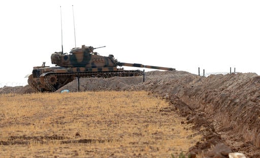 A Turkish tank is stationed near the Syrian border