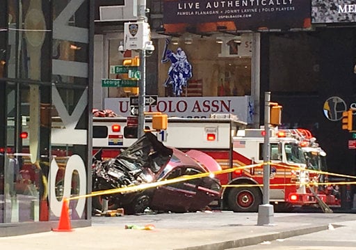 A smashed car sits on the corner of Broadway and 45th Street in New York's Times Square after driving through a crowd of pedestrians Thursday
