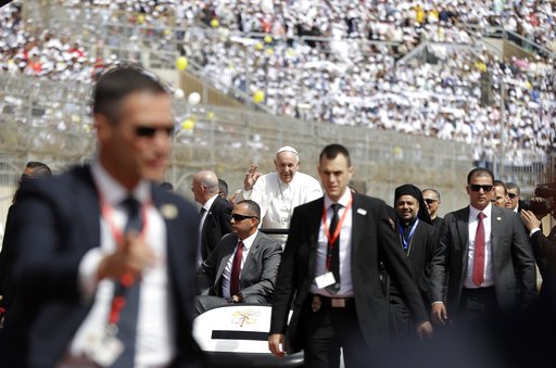 Pope Francis waves as he arrives to celebrate Mass for Egypt's tiny Catholic community