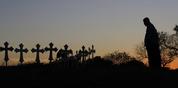 Isaac Hernandez and his wife Crystal visit a line of crosses before a vigil for the victims of the First Baptist Church shooting