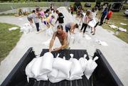 Ryan Kaye loads sandbags into his truck at a makeshift filling station provided by the county as protection ahead of Hurricane Irma