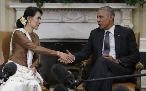 President Barack Obama shakes hands with Myanmar's leader Aung San Suu Kyi as they speak to media at the conclusion of a meeting in the Oval Office of the White House in Washington