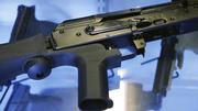 A little-known device called a "bump stock" is attached to a semi-automatic rifle at the Gun Vault store and shooting range Wednesday