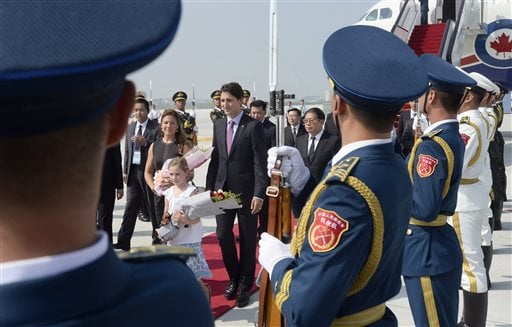An honor guard of the People's Liberation Army stand at attention as Canadian Prime Minister Justin Trudeau