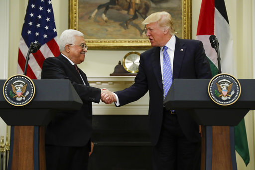President Donald Trump shakes hands with Palestinian leader Mahmoud Abbas after their statements in the Roosevelt Room of the White House in Washington