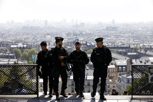 Riot police officers patrol in the Montmartre district Friday