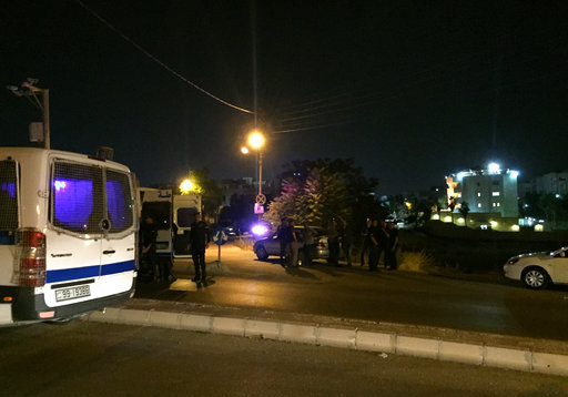 Security officials park near the approach toward the Israeli embassy in Amman