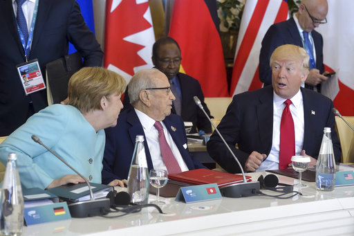 US President Donald Trump shares a word with German Chancellor Angela Merkel