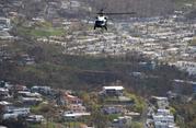 Marine One helicopter carrying President Donald Trump surveys areas impacted by Hurricane Maria