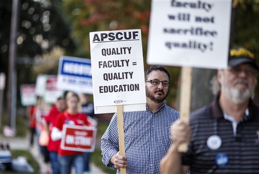 Faculty members of the Association of Pennsylvania State College and University Faculties take part in a faculty union strike at Dixon University Center in Harrisburg