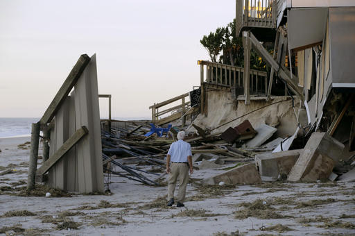 H.V. Bailey looks at damage to a neighbor's home at Ponte Vedra Beach