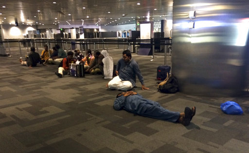 Passengers of cancelled flights wait in Hamad International Airport (HIA) in Doha