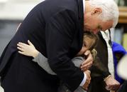 Vice President Mike Pence hugs Evelyn Holcombe at Florseville High School during a stop