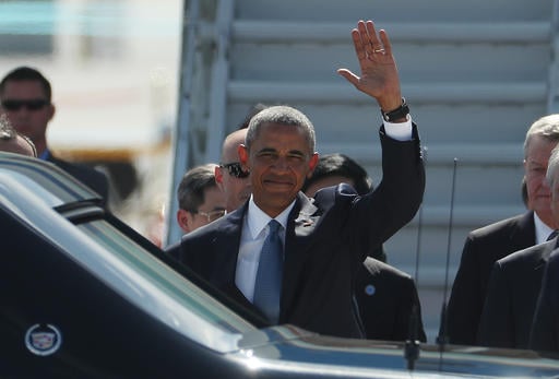 U.S. President Barack Obama waves has he arrives at the Hangzhou Xiaoshan International Airport