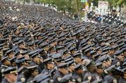 Police officers stand at attention as the funeral procession for slain police officer Miosotis Familia leaves at the World Changers Church after her funeral service