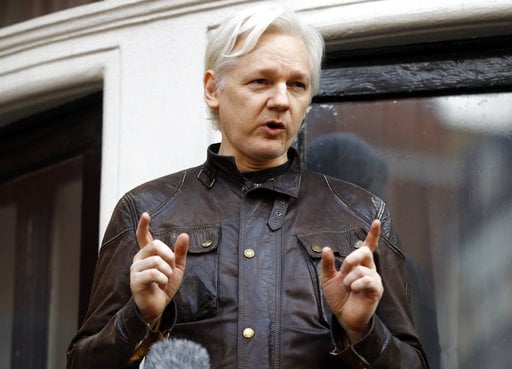 Julian Assange speaks to the media outside the Ecuadorian embassy in London