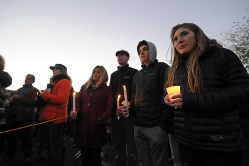 Mourners hold candles Monday