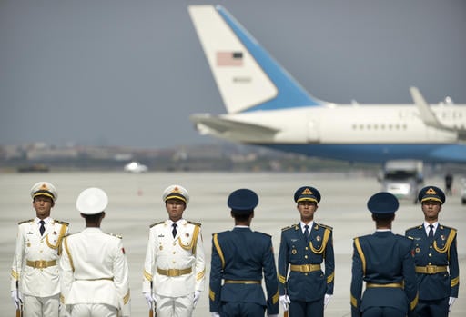 Members of a Chinese honor guard line up near a U.S. Air Force plane before the arrival of U.S. President Barack Obama at the Hangzhou Xiaoshan International Airport