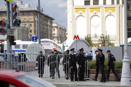 Russian police officers talk as they stand behind barricades in downtown Moscow