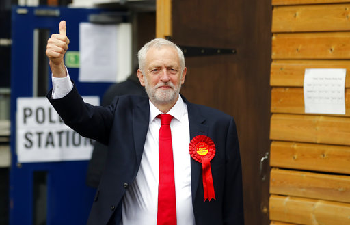 Britain's Labour party leader Jeremy Corbyn gestures as he arrives to vote in the general election at a polling station in London