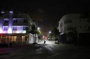 A lone pedestrian walks through the usual bustling South Beach ahead of Hurricane Irma in Miami Beach