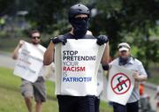Counterprotesters hold signs before conservative organizers begin a planned "Free Speech" rally on Boston Common