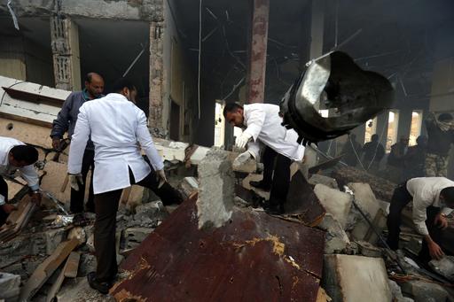Medics search for bodies under the rubble of a funeral hall that was targeted by a Saudi-led coalition airstrike in Sanaa