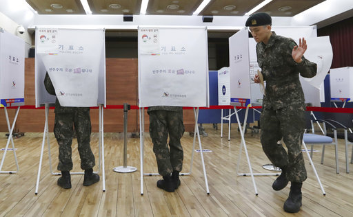 A South Korean soldier exits a polling booth to cast his early vote for the May 9 presidential election at a local polling station in Seoul